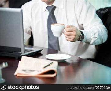 Businessman with a cup of coffee, close-up