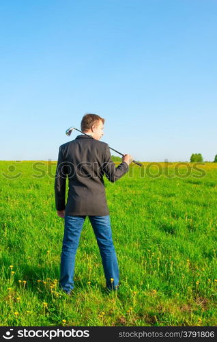 businessman with a golf club on the field