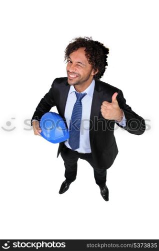 Businessman with a hardhat and the thumbs up