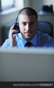 businessman with a headset portrait at bright call center helpdesk support office