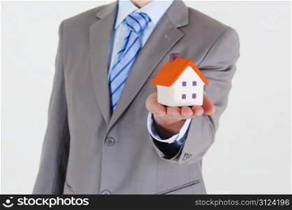Businessman with a house in his hand