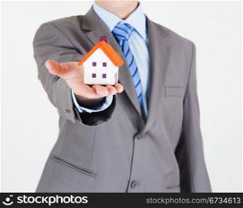 Businessman with a house in his hand