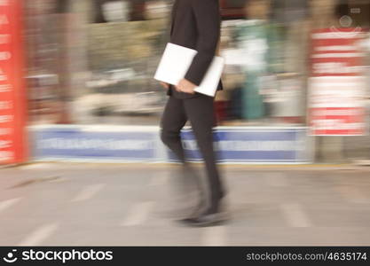 Businessman with a laptop walking , INDIA , DELHI