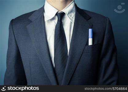 Businessman with a marker in his front suit pocket