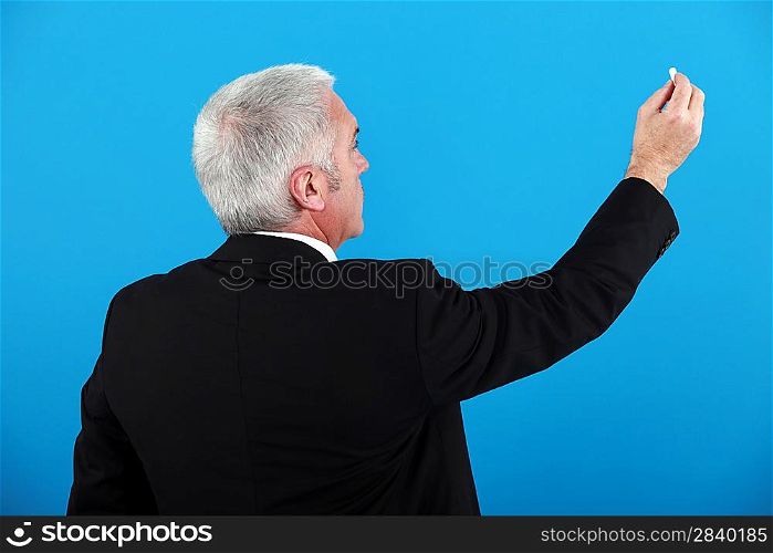 Businessman with a piece of chalk
