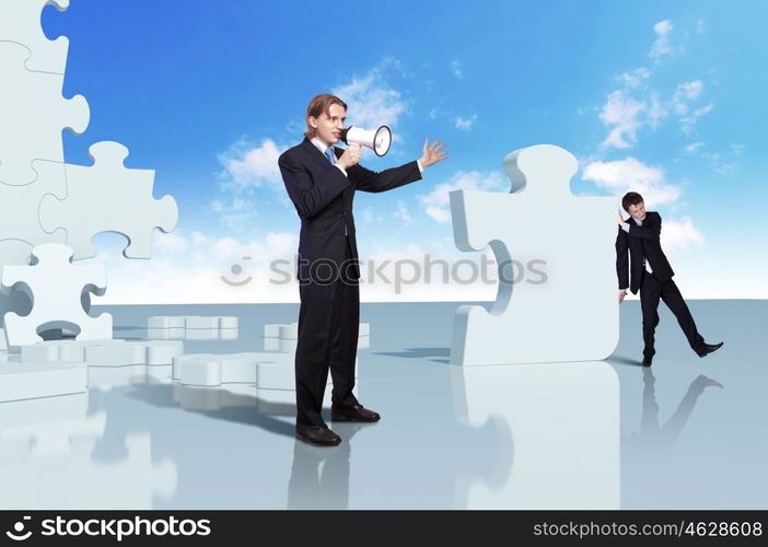 Businessman with a puzzle pieces on the background