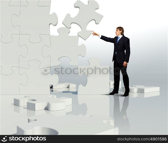 Businessman with a puzzle pieces on the background