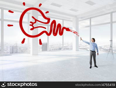 Businessman with aerosol can. Concept of creativity with businessman in office spraying paint from balloon