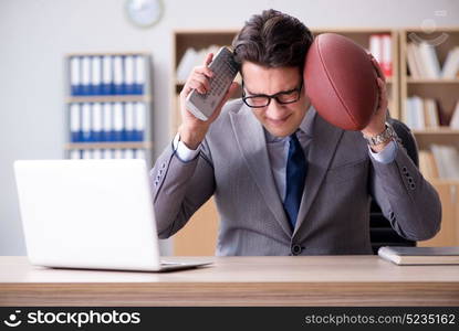 Businessman with american football in office