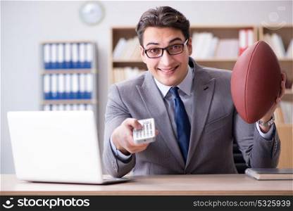 Businessman with american football in office