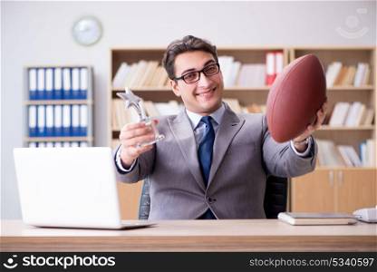 Businessman with american football in office