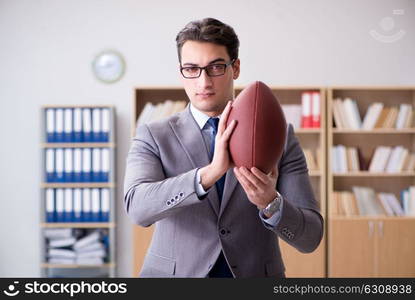 Businessman with american football in office