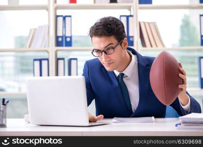 Businessman with american football in office