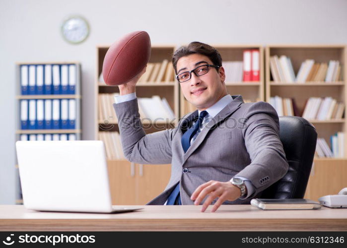 Businessman with american football in office