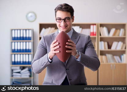 Businessman with american football in office