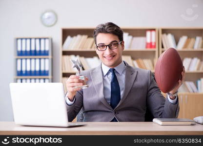 Businessman with american football in office