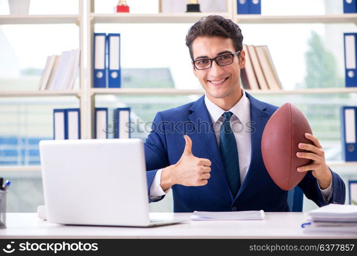 Businessman with american football in office