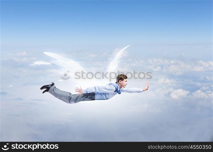 Businessman with angel wings. Young businessman with drawn wings flying in sky