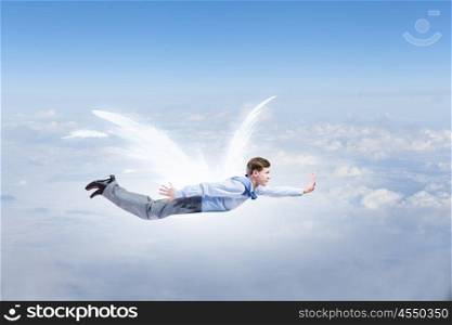 Businessman with angel wings. Young businessman with drawn wings flying in sky