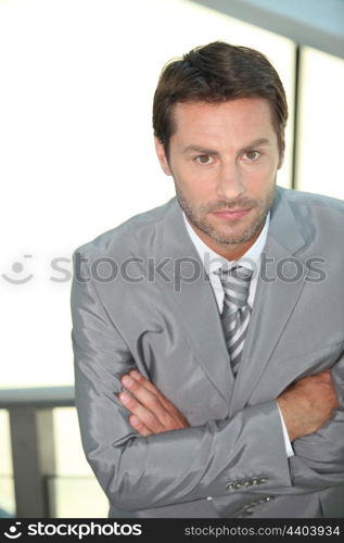 Businessman with arms crossed.