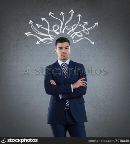 Businessman with arrows drawn on a wall overhead. Many ways, strategy, choices concept