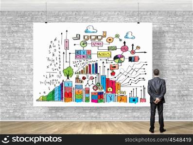 Businessman with banner. Image of businessman standing with back and looking at banner with business plan