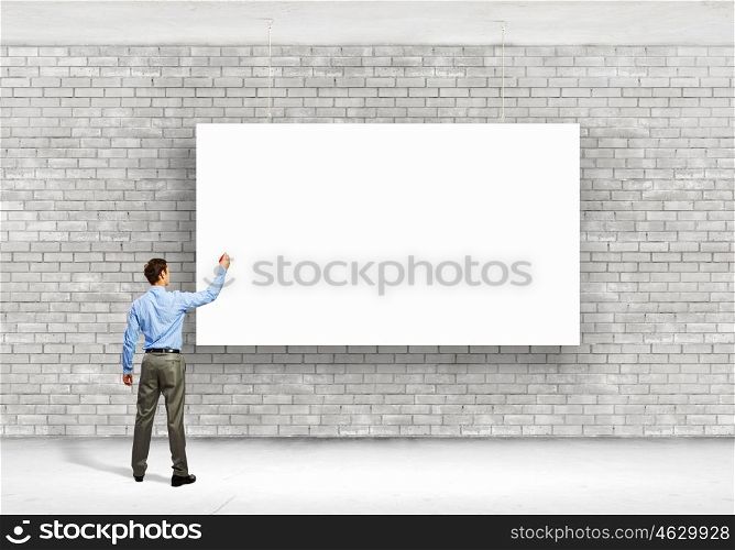 Businessman with banner. Image of businessman standing with back and writing on blank banner
