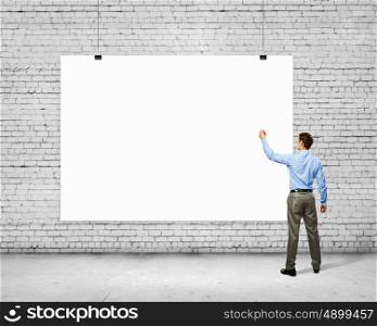 Businessman with banner. Image of businessman standing with back and writing on blank banner