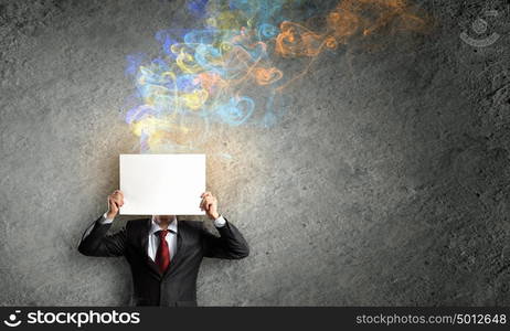 Businessman with banner. Unrecognizable businessman holding white blank paper. Place for text