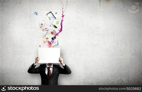 Businessman with banner. Unrecognizable businessman holding white blank paper. Place for text