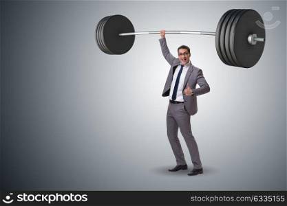 Businessman with barbell in heavy lifting concept