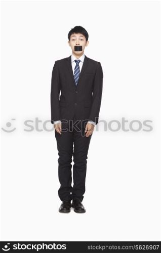 Businessman with black tape over mouth