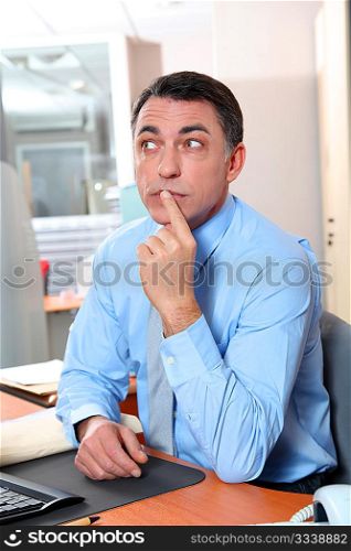 Businessman with blue shirt working in the office