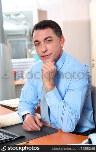Businessman with blue shirt working in the office