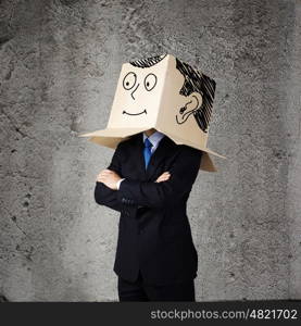 Businessman with box on head. Businessman wearing carton box with smileys on head