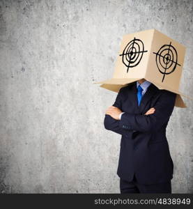 Businessman with box on head. Man wearing carton box with target on head