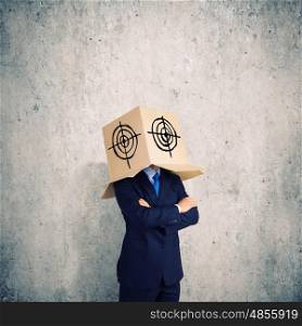 Businessman with box on head. Man wearing carton box with target on head