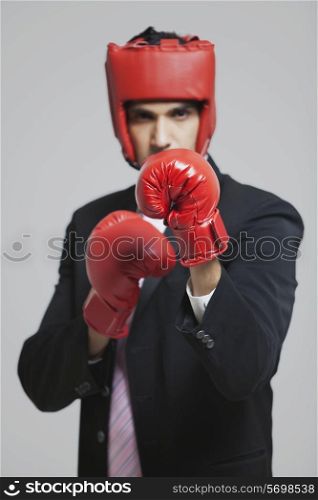Businessman with boxing gloves in boxing stance