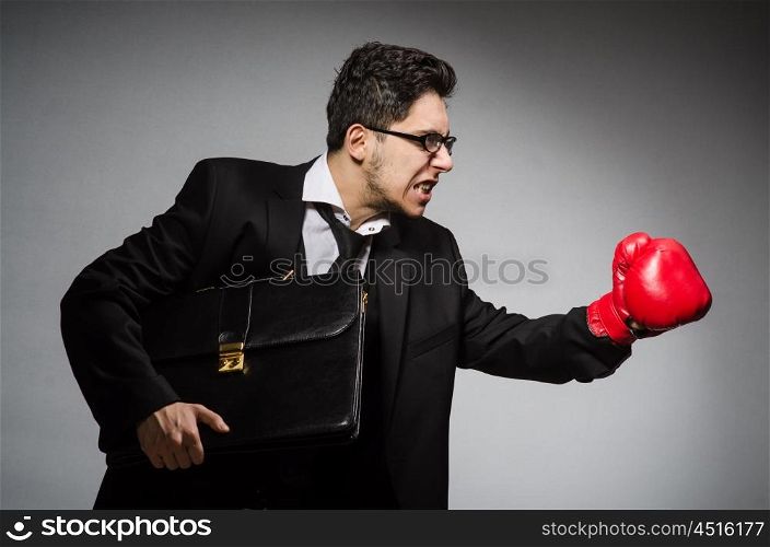 Businessman with boxing gloves in sport concept