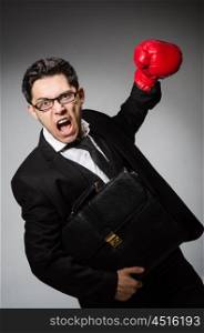 Businessman with boxing gloves in sport concept