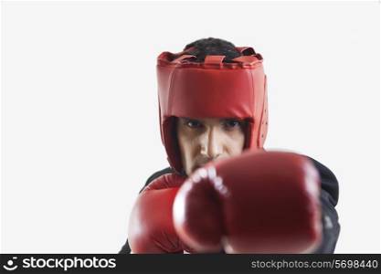 Businessman with boxing gloves punching