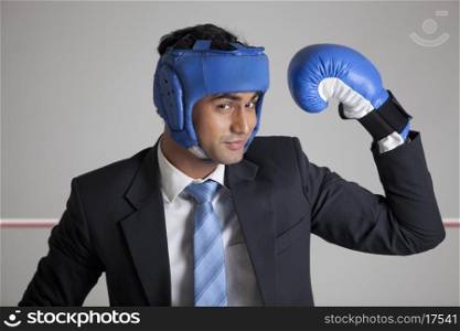 Businessman with boxing gloves raising his arm