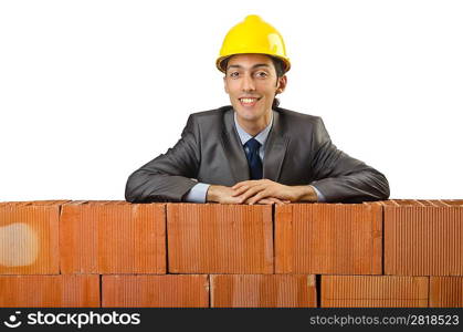 Businessman with bricks on white