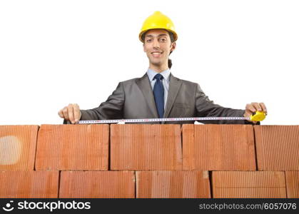 Businessman with bricks on white