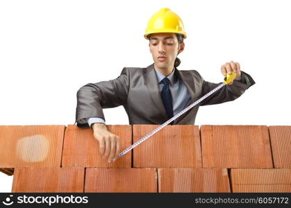 Businessman with bricks on white