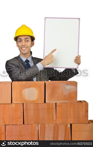 Businessman with bricks on white