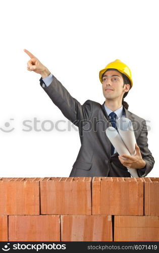 Businessman with bricks on white