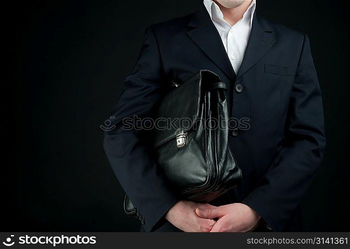 businessman with briefcase over black background
