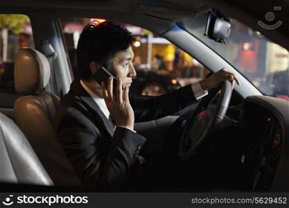 Businessman With Cell Phone In Car