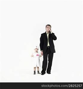 Businessman with child in costumes on white background